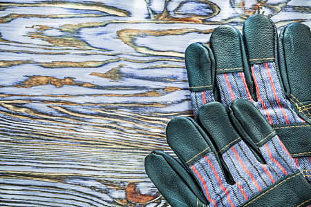Working gloves on wooden board.