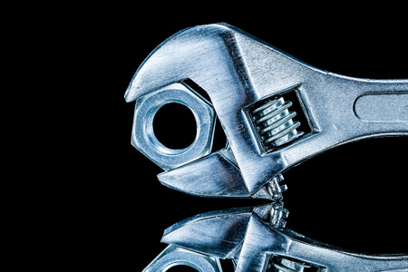 Construction nut adjustable wrench on black background.の写真素材