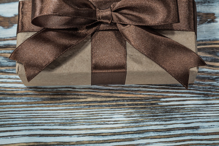 Brown gift box on wooden background.