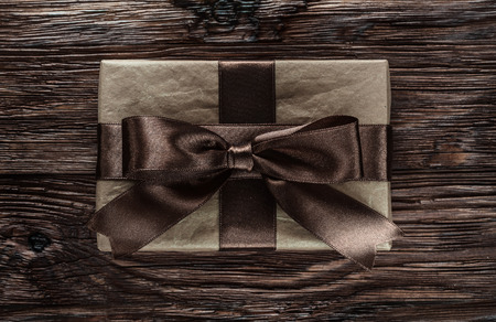Brown present box on vintage wooden board.の写真素材