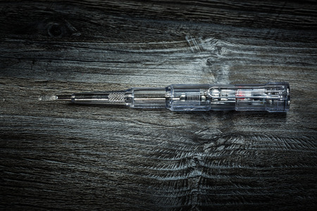 Insulated screwdriver on vintage wooden board.の写真素材