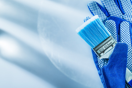 Safety gloves paintbrush on white background horizontal image.