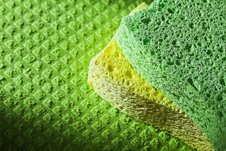 Cleaning kitchen sponges on dishcloth.