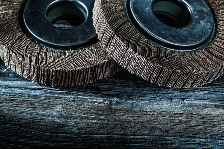 Used abrasive wheels on vintage wooden board.の写真素材