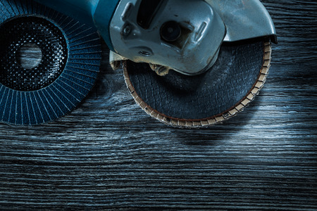 Angle grinder radial polishing discs on vintage wooden board.の写真素材