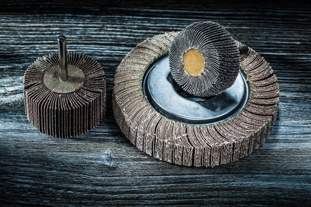 Used rotary sanding wheels on vintage wooden board.の写真素材