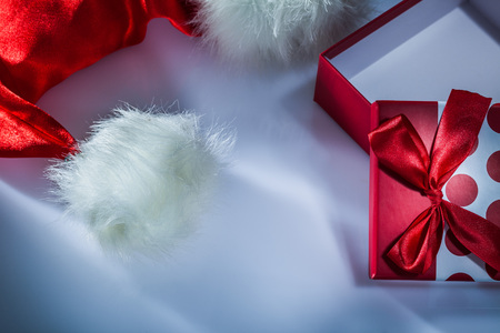 Santa cap wrapped gift box on white background.の写真素材