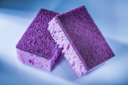 New violet kitchen sponges on white surface.の写真素材