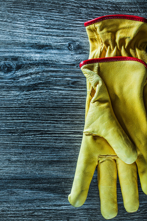 Pair of safety gloves on wooden board.の写真素材