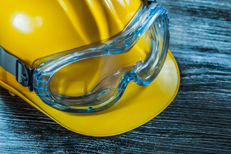 Safety glasses hard hat on vintage wooden board.の写真素材