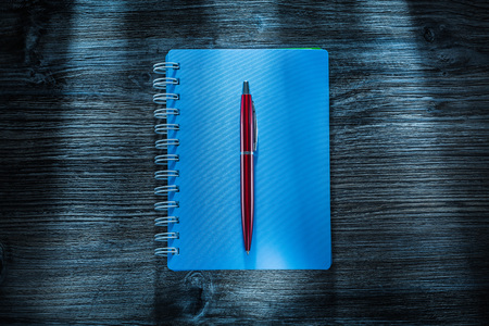 Set of notebooks pen on vintage wooden board.の写真素材