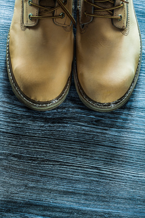 Pair of safety boots on wooden board.の写真素材