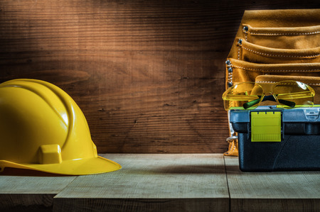 helmet glasses toolbox belt on woodの写真素材