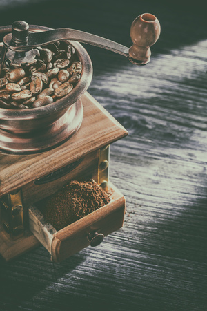 Coffee mill crops on wooden board.の写真素材