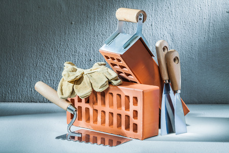 bricks gloves and plastering tools on concretteの写真素材