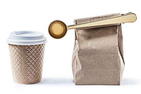 coffee papercup and paperbag with big golden scoop isolatedの写真素材