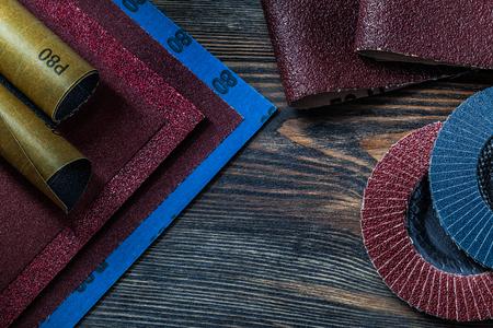 abrasive  tools sand paper and abrasive wheels on vintage woodの写真素材