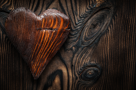 single vintage wood valentine toy heart on wooden boardの写真素材