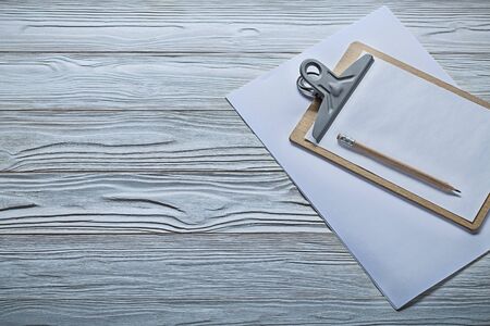 small clipboard with pencil on vintage white wood