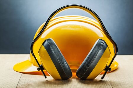 earphones with yellow construction helmetの写真素材