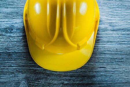 Yellow safety cap on wooden board.の写真素材