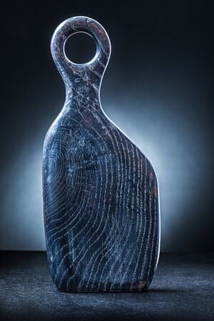 gray - dark blue vintage chopping board on gradient backgroundの写真素材