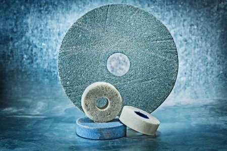 various size abrasive discs on metalic background