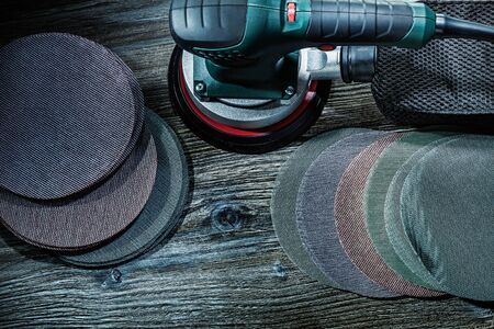 elcetric finishing hand sander with sanding discs on vintage woodの写真素材