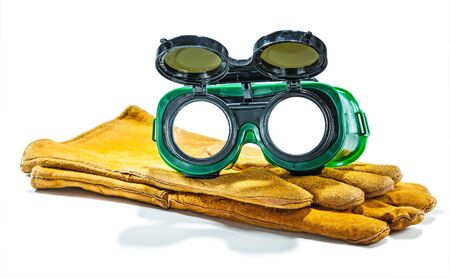 welder working goggles on pair of gloves isolated
