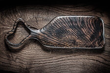 dark serving board on vintage woodの写真素材
