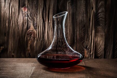 decanter with red wine on vintage backgroundの写真素材