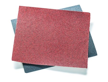 red and black sheets of abrasive paper isolated on whiteの写真素材