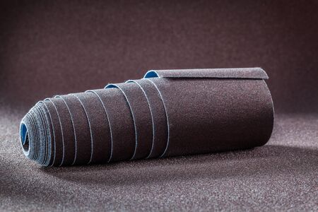big roll of sandpaper on brown abrasive backgroundの写真素材