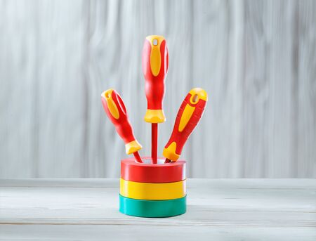 electrical tools three screwdrivers standing in rolls of insulation tapeの写真素材