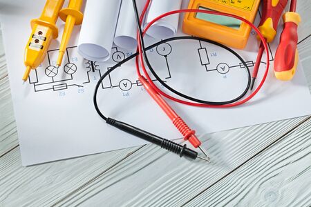 electric tester and multitester insulated screwdrivers blueprints on white vintage woodの写真素材