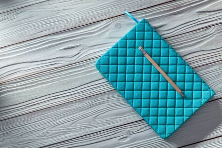 blue notepad with classic pencil on white vintage wooden boardsの写真素材