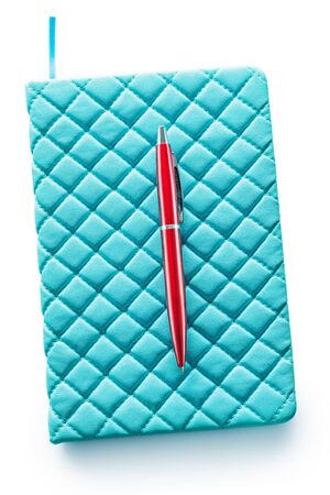 blue soft leather note pad and red ballpoint pen isolated on white backgroundの写真素材