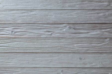 white vintage wooden texture with side light and horizontal oriented planks top view surface of the table to shoot flat layの写真素材