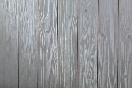 white vintage wooden texture with side light and vertical oriented planks top view surface of the table to shoot flat layの写真素材