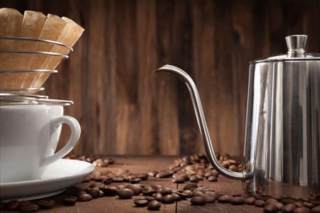 Alternatife Coffee Brewing. Pour Over Drip Coffee Kettle Gooseneck Pot Coffeemaker. Coffee Paper Filter In Corded Holder On White Ceramic Cup.の写真素材