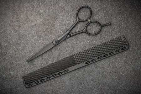 Black Scissors And Comb. On Black Background. Barber Professional Tools. Male Haircut Fashionの写真素材