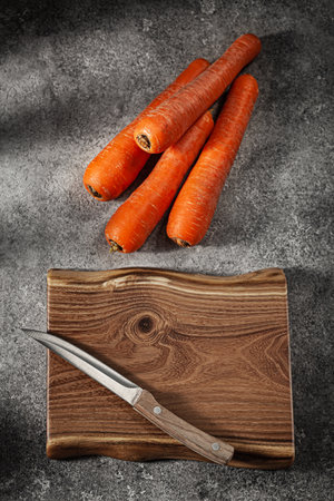Carrots And Chopping Board With Kitchen Knifeの写真素材