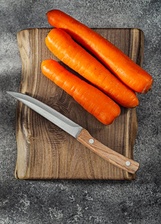Carrots On Kitchen Wooden Board And Knifeの写真素材