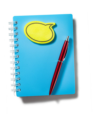 Blue Notepad With Yellow Sticky Note Message And Red Ballpoint Pen Isolated On Whiteの写真素材
