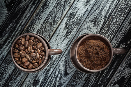 Coffee Ground And Coffeebeans In Cups On Vintage Wood Backgroundの写真素材