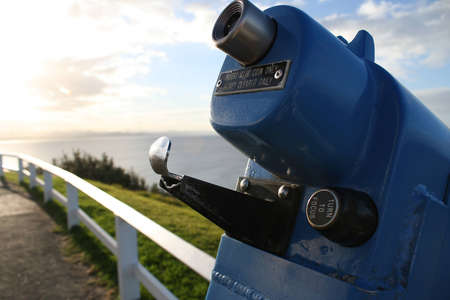 Spyglass with sunset and ocean in the background.の写真素材
