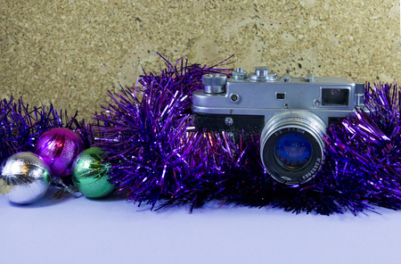 retro christmass camera in tinsel with ballsの写真素材