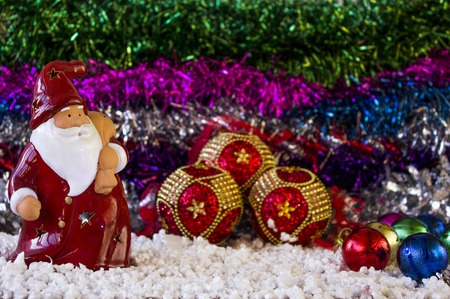 Red Toy Santa Clause close-up on the tinsel, as babackgroundの写真素材