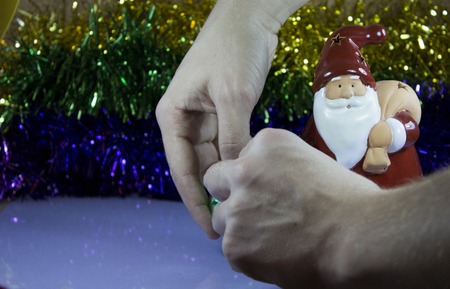 red toy santa clause with reflection on the tinsel, as babackgroundの写真素材