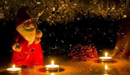 night red santa clause with candles on the tinsel, as babackgroundの写真素材